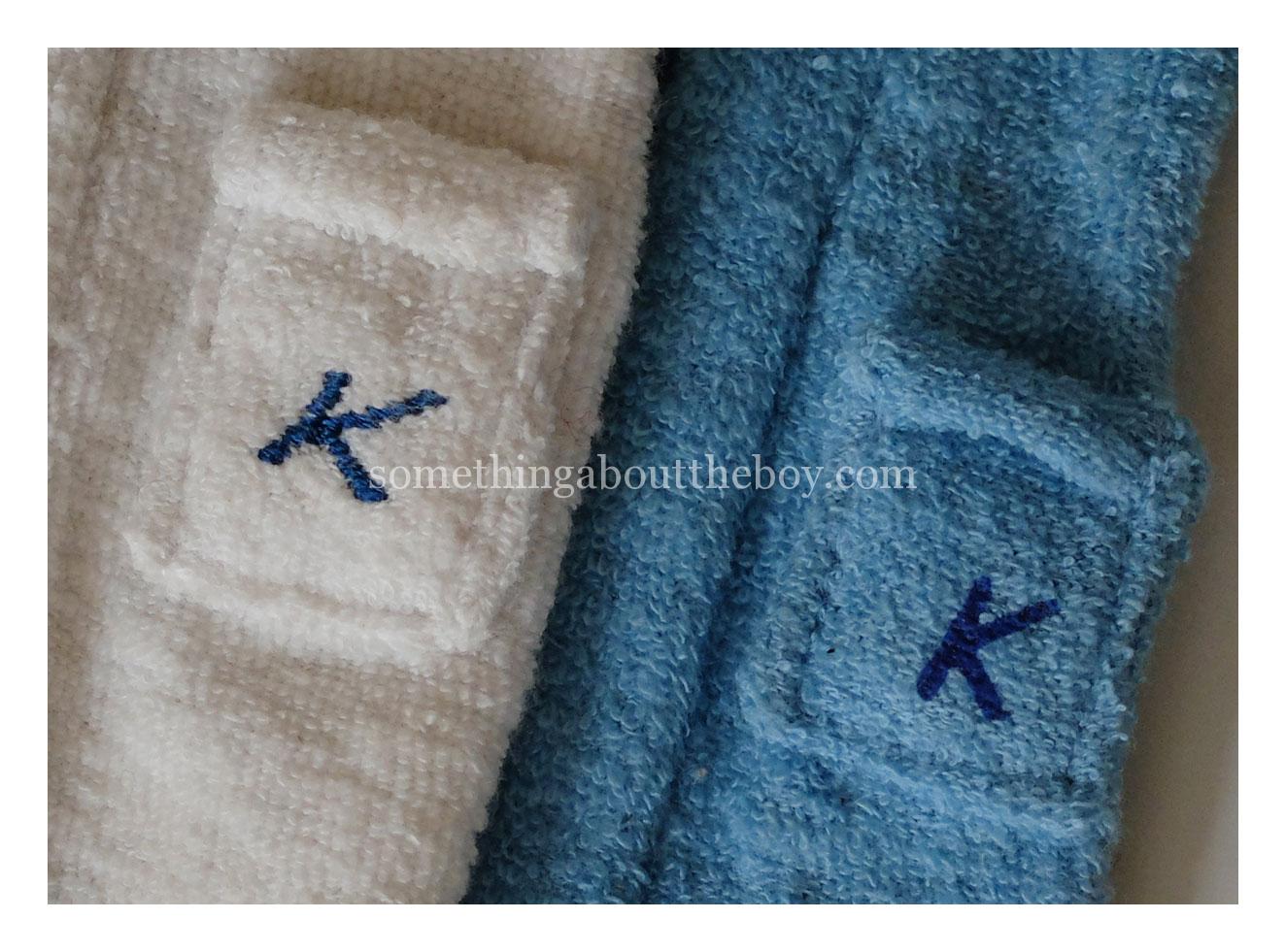 #784 Terry Togs white and deeper blue robes, showing 'K' stitched on (left) and stamped on (right)